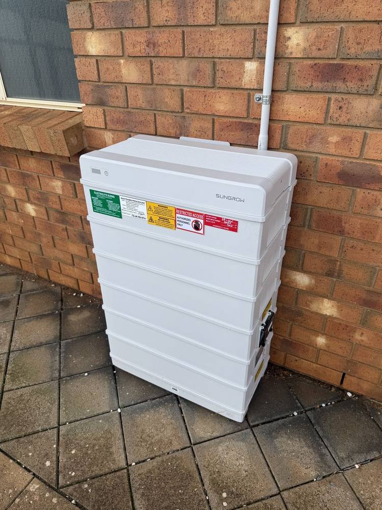 Home battery stack installed on a garage wall